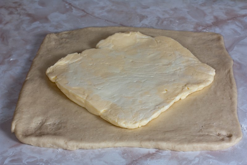 Place the fat square diagonally on the dough