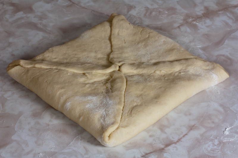 Fold the corners of the dough over the fat square