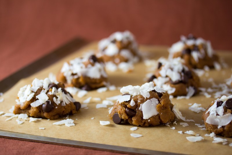 Form the cookies into balls then press the shredded coconut into them